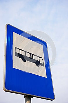 Vertical low angle of a blue bus stop sign