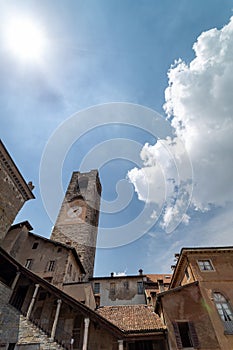 Vertical low angle of the civic tower Campanone in the heart of Piazza Vecchia against a bright sky