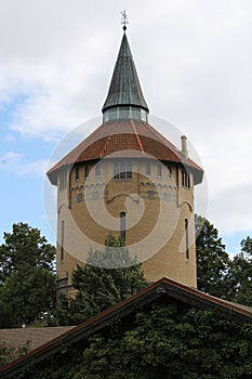 Vertical low-angle closeup of Pildammsparken with trees around and cloudy sky background