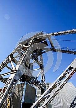 Vertical low angle of a gold mining manufactory on background of the blue sky