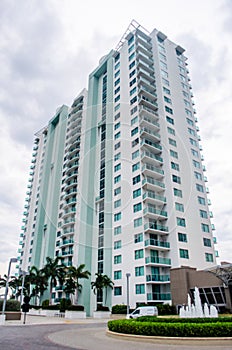 Vertical low angle of high-rise building against cloudy sky