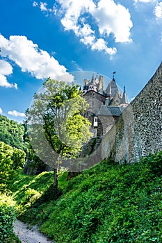 Vertical low angle shot of the Eltz Castle surrounded by trees in Wierschem, Germany