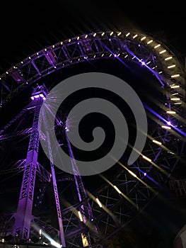 Vertical low angle shot of the famous Ferris Wheel in Prater, Vienna illuminated at night