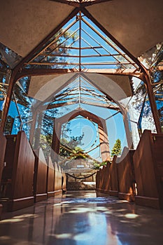 Vertical low angle shot of the Wayfarers Chapel in the daytime with a clear blue sky