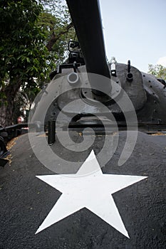 Vertical medium low angle view of front and turret of captured US Army tank on display in Vietnam