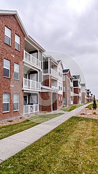 Vertical Modern brick apartment complex with balconies day light