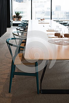 Vertical of modern interior design for an office with a long table and chairs