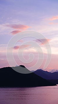 Vertical mountain, cloud and ocean at sunset