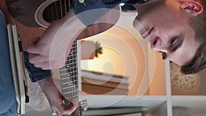 Vertical music writing guitar man composing home