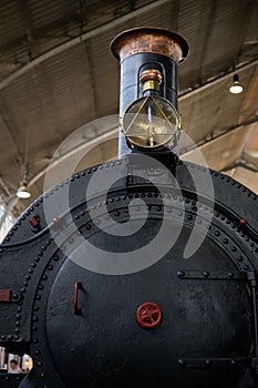 Vertical of an old Spanish steam locomotive at Delicias station in Madrid, Spain photo