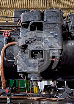 Vertical of an old Spanish steam locomotive detail at Delicias station in Madrid, Spain photo