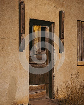 Vertical of an old wooden door of an abandoned house along Santa Fe Trail Byway in Colorado