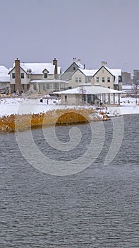 Vertical Oquirrh lake with view of snowy lakefront homes