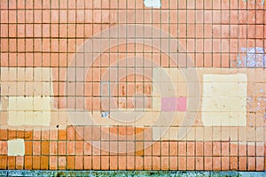 Vertical orange concrete tiles brick wall, pink or yellow paint. Text copy space