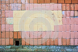 Vertical orange concrete tiles brick wall, pink or yellow paint. Text copy space