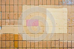Vertical orange concrete tiles brick wall, pink or yellow paint. Text copy space