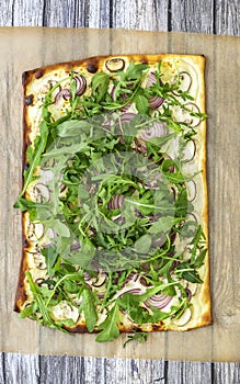 Vertical orientation of fresh baked flammkuchen - Traditional German pizza or french tarte flambee in vegetarian recipe