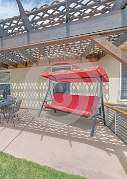 Vertical Outdoor patio of a house with loung seats and covered barbecue griller