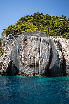 Vertical Outdoor Scene of Rocky Cliff with Green Trees in Zakynthos