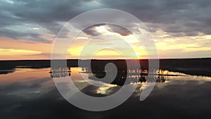 A vertical panorama (tilt) of forest, lake and a beautiful sunset sky.