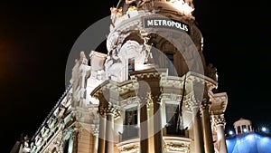 Vertical panoramic Metropolis Building illuminated at night on the Gran Via street in Madrid, Spain footage.