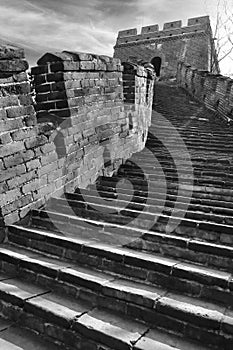Vertical panoramic monochrome view of stairs on the Mutianyu section of the Great Wall of China leading to a watch tower
