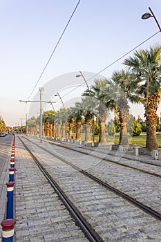 Vertical perspective shot of tramway line with pedestrian stones at sunset time in Izmir at Turkey