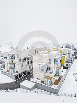 Vertical photo aerial view of residential complex, modern apartment buildings on a snowy winter day