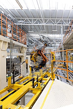Vertical photo of automobile production line. Welding car body. Modern car assembly plant. Auto industry