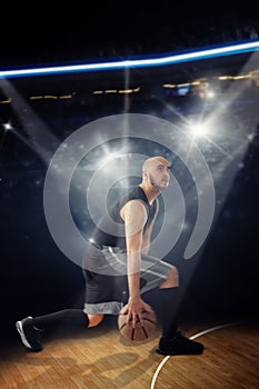 Vertical photo of bald professional basketball player in the game dribbles