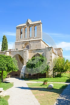 Vertical photo of beautiful Bellapais Abbey in Northern Cyprus taken with blue sky above. The ancient monastery is one of the most