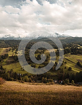 Vertical photo of Belianske Tatry Mountains with beautiful meadow valley on foreground. Amazing sunset zamagurie with warm and