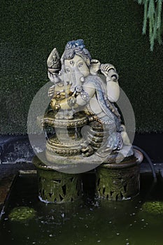 Sacred Water: Ganesha Statue at Fountain photo