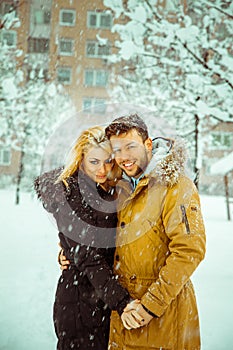 Vertical photo of betrothed couple in love looking at camera and