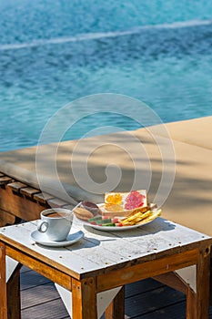 Vertical photo of breakfast at the swimming pool