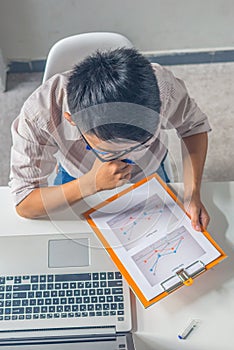 Vertical photo of business employee checking financial document report