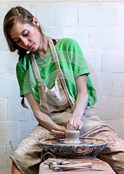 Vertical photo of charming nice-looking lovely cute sweet gorgeous workmanship focused confident artisan artist lady in her photo