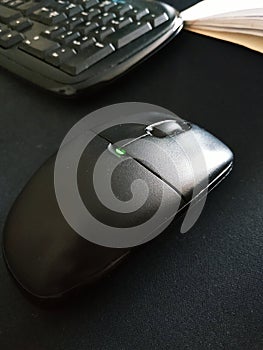 Vertical photo of a computer mouse. Working process at the computer. Computer mouse with LED.