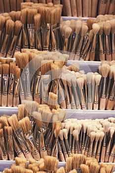 Vertical photo. Different brushes in the store for artists. A wide and varied selection of brushes for different drawing styles.