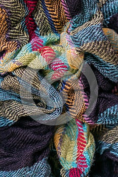 Vertical photo of the fragment of multicolored fabric texture old scarf