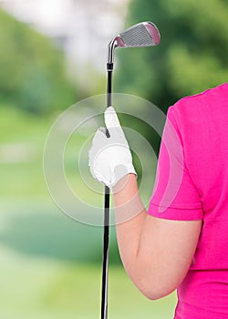 Vertical Photo gloved hand with a golf club and a space