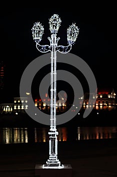 Vertical photo of a glowing pole with LED lamps.