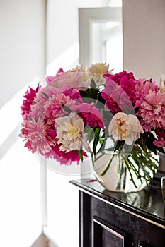 Vertical photo of a gorgeous bouquet of blooming peonies