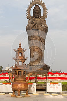 Vertical photo of Guanying Buddha statue at Guiyuan Buddhist Temple in Wuhan Hubei China