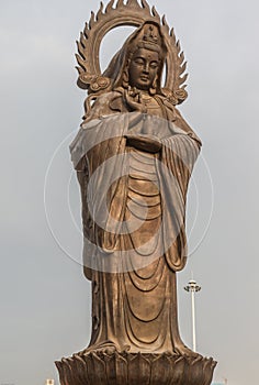 Vertical photo of Guanying Buddha statue at Guiyuan Buddhist Temple in Wuhan Hubei China