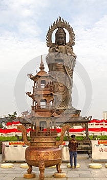 Vertical photo of Guanying Buddha statue at Guiyuan Buddhist Temple in Wuhan Hubei China