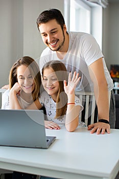 Vertical photo of a happy family during online video call. Communication with relatives via the Internet.