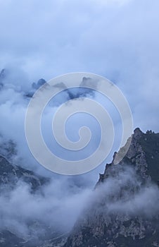 vertical photo of mountains in clouds