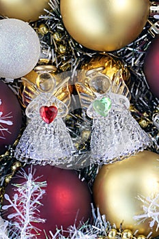 vertical photo with red and gold Christmas balls with angels. Christmas background. New Year concept.