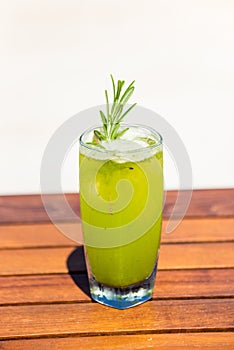 Vertical photo of refreshing garden delight cocktail on wooden table at the beach